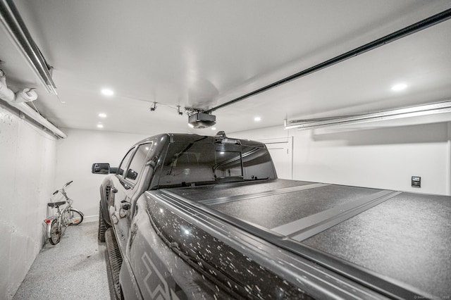 garage featuring a garage door opener and recessed lighting