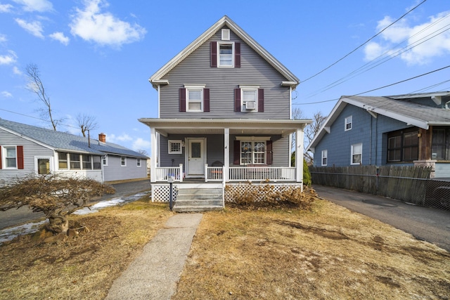 view of front of property with covered porch and fence