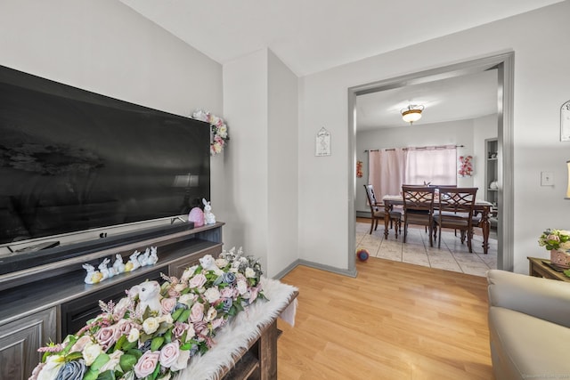 living area with light wood finished floors and baseboards