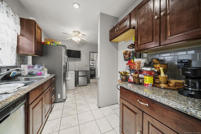 kitchen featuring ceiling fan, appliances with stainless steel finishes, tasteful backsplash, and a sink