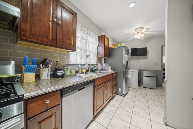 kitchen with stainless steel appliances, a sink, marble finish floor, backsplash, and range hood