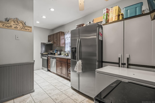 kitchen featuring tasteful backsplash, marble finish floor, stainless steel appliances, dark brown cabinets, and under cabinet range hood