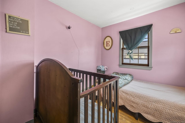 bedroom with wood finished floors