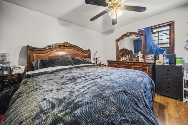 bedroom with ceiling fan and wood finished floors