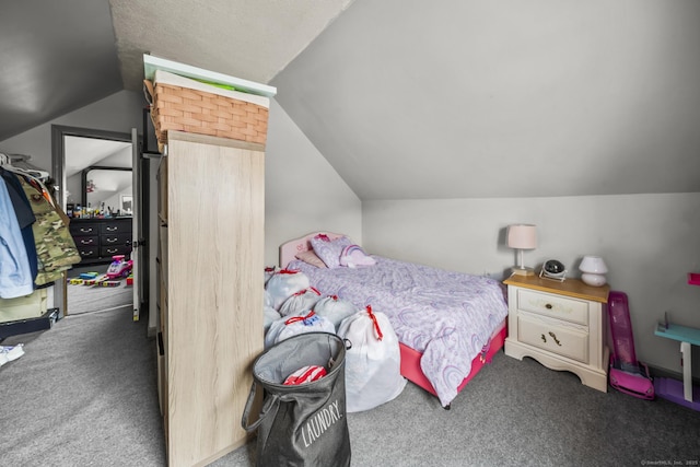 bedroom with vaulted ceiling and carpet floors