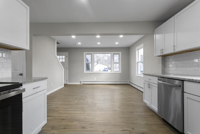 kitchen with electric range oven, dishwasher, light wood-style floors, white cabinetry, and recessed lighting