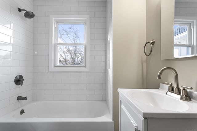 bathroom featuring plenty of natural light, shower / tub combination, and vanity