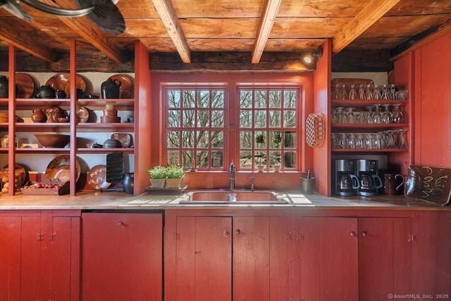 interior space with a sink, beamed ceiling, and wooden ceiling