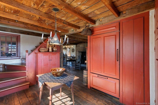 dining space with dark wood-style floors, beam ceiling, wooden ceiling, and stairs