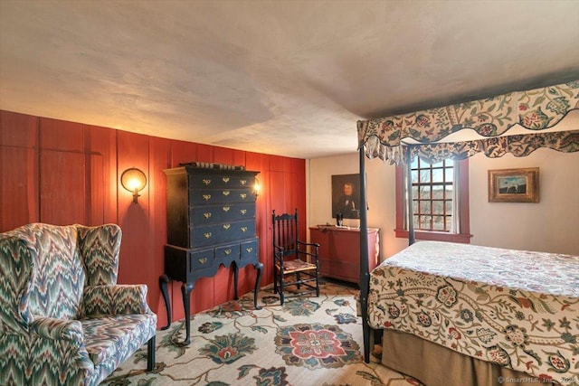 bedroom featuring wood walls