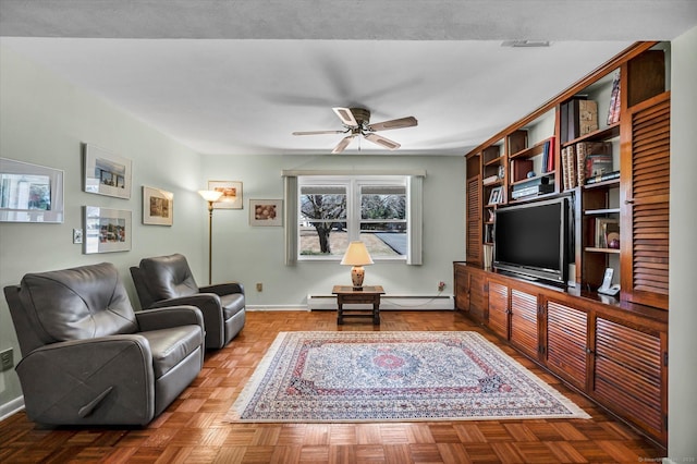 living area with a baseboard radiator, ceiling fan, and baseboards