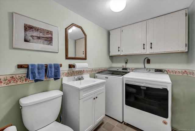 laundry room with laundry area, a sink, and washer and dryer