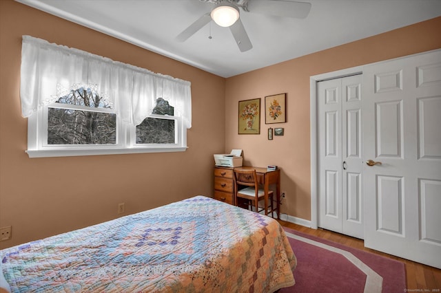 bedroom with ceiling fan, a closet, baseboards, and wood finished floors