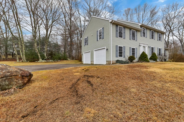 colonial inspired home featuring driveway and an attached garage