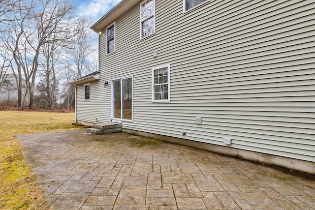 back of property featuring a lawn and a patio area