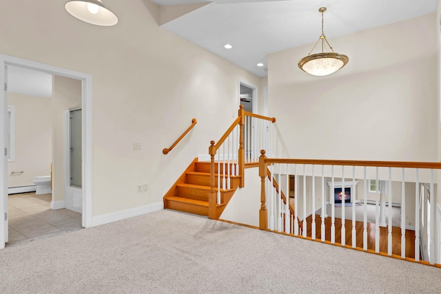 stairway featuring a glass covered fireplace, recessed lighting, carpet, baseboards, and baseboard heating