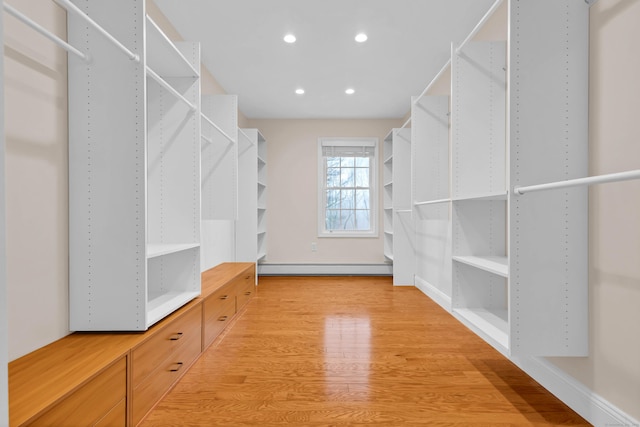 walk in closet featuring light wood-style flooring and a baseboard radiator