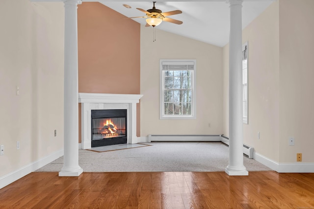 unfurnished living room featuring a fireplace with flush hearth, ornate columns, and wood finished floors