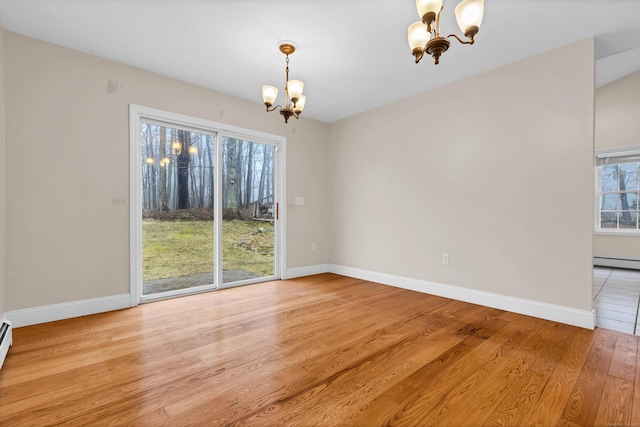 unfurnished dining area featuring a chandelier, light wood finished floors, baseboards, and a baseboard radiator