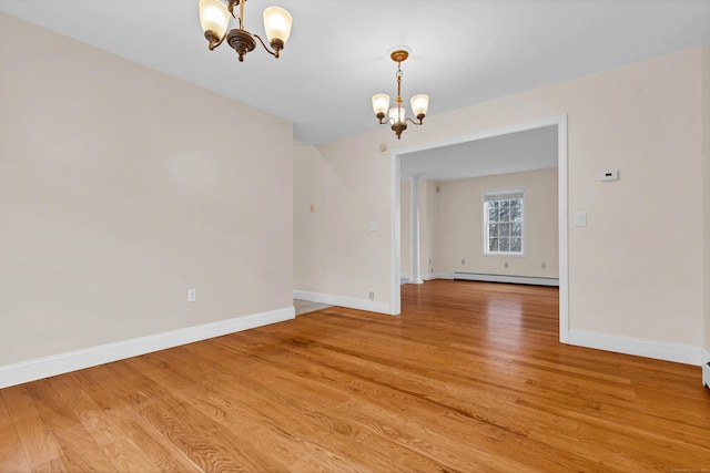 unfurnished dining area with light wood-type flooring, baseboards, a baseboard radiator, and a chandelier