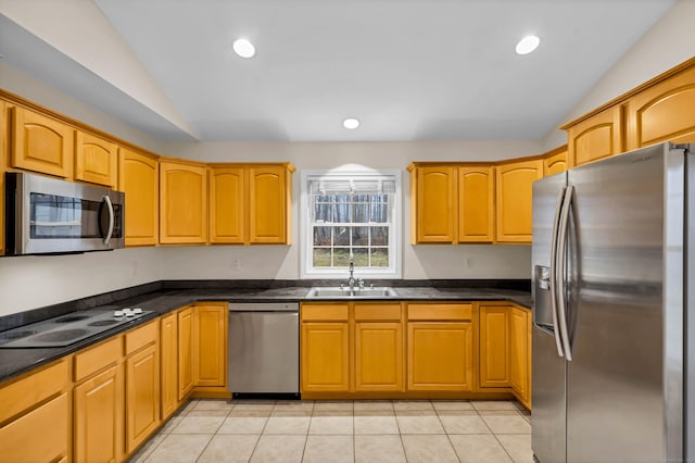 kitchen featuring lofted ceiling, light tile patterned floors, recessed lighting, appliances with stainless steel finishes, and a sink