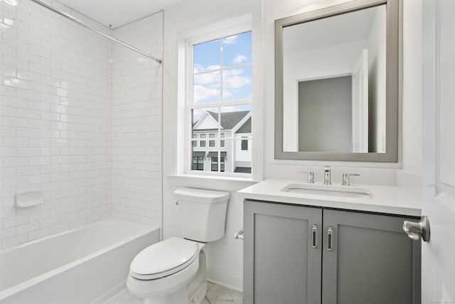 bathroom featuring toilet, baseboards, shower / bathing tub combination, and vanity