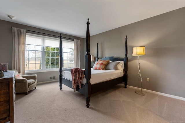 bedroom featuring light colored carpet, visible vents, and baseboards