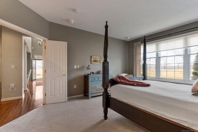 bedroom with carpet floors, baseboards, and visible vents