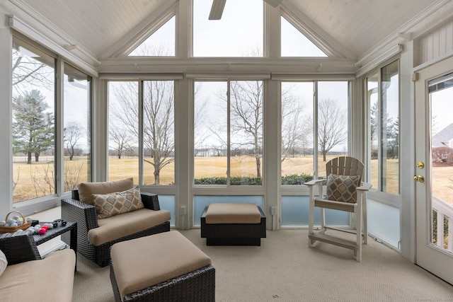 sunroom with lofted ceiling, plenty of natural light, and a ceiling fan