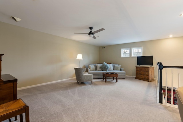 living area featuring light carpet, ceiling fan, visible vents, and baseboards