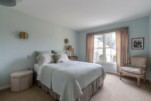 bedroom featuring light colored carpet and baseboards