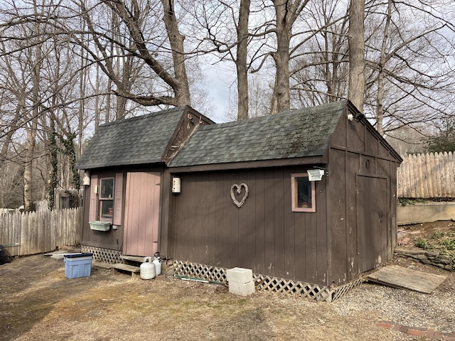 view of outbuilding featuring an outbuilding and fence