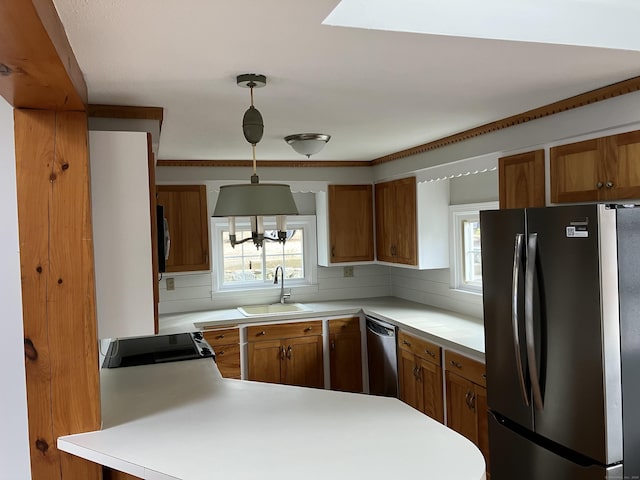 kitchen featuring light countertops, appliances with stainless steel finishes, and a sink