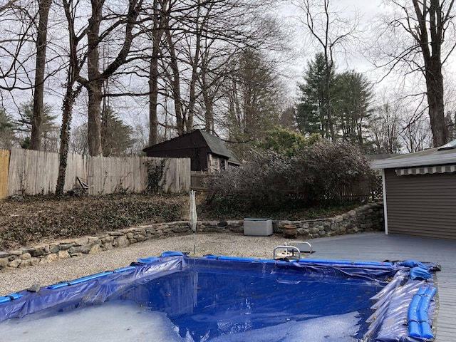 view of swimming pool featuring fence