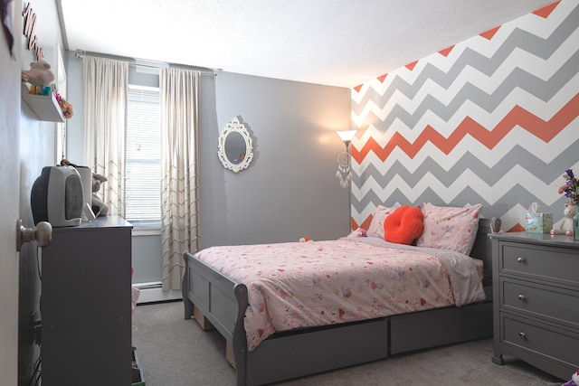 bedroom with carpet, an accent wall, baseboard heating, and a textured ceiling