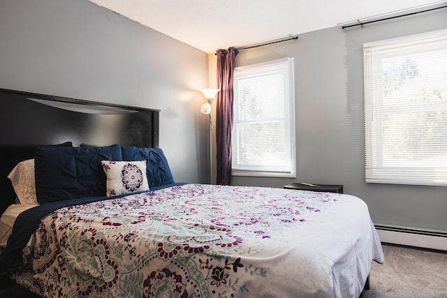 carpeted bedroom featuring baseboard heating