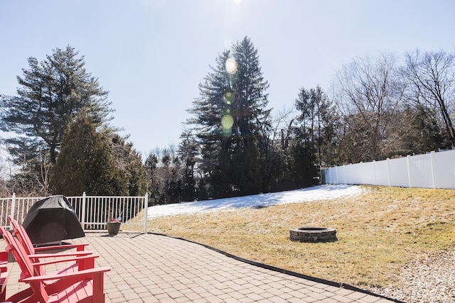 view of patio featuring fence and a fire pit