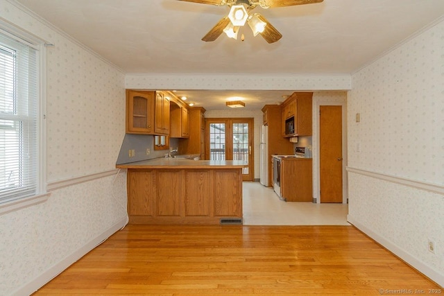 kitchen with wainscoting and wallpapered walls