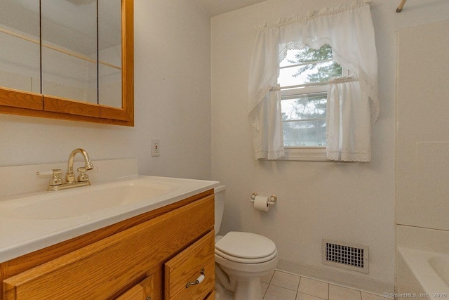 full bathroom featuring visible vents, toilet, a tub to relax in, tile patterned flooring, and vanity