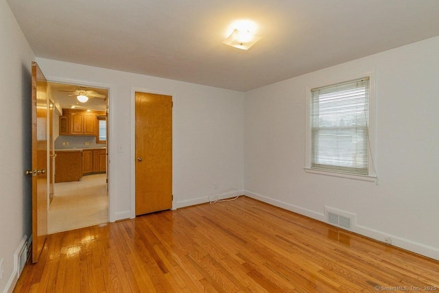 unfurnished bedroom with baseboards, visible vents, and light wood-type flooring