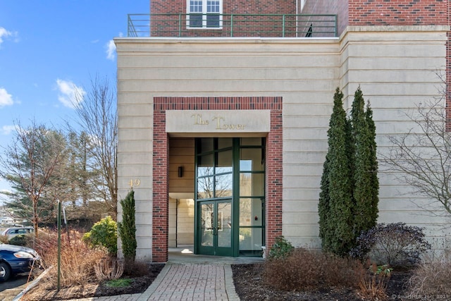 property entrance with french doors and a balcony