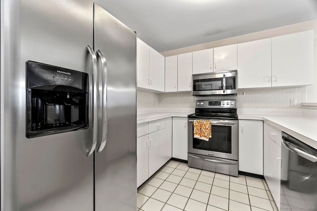 kitchen featuring light tile patterned floors, stainless steel appliances, white cabinets, and light countertops