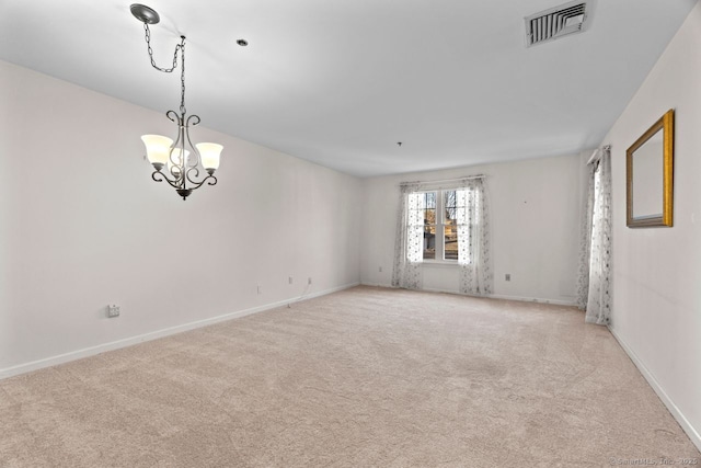 unfurnished room featuring visible vents, light carpet, a notable chandelier, and baseboards