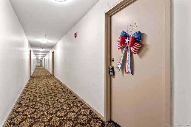 corridor featuring carpet and baseboards