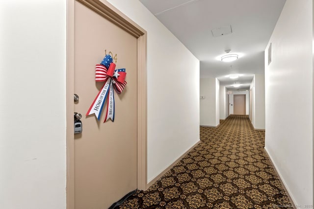 hall with visible vents and baseboards