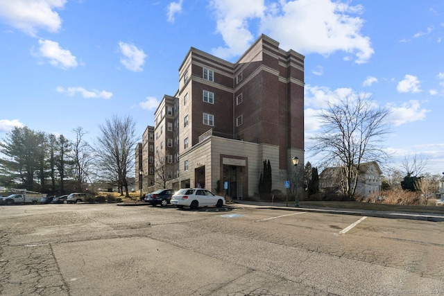 view of building exterior featuring uncovered parking