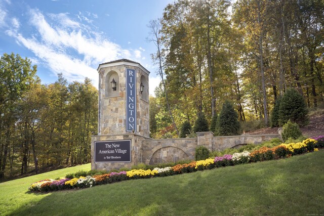 community sign featuring a lawn