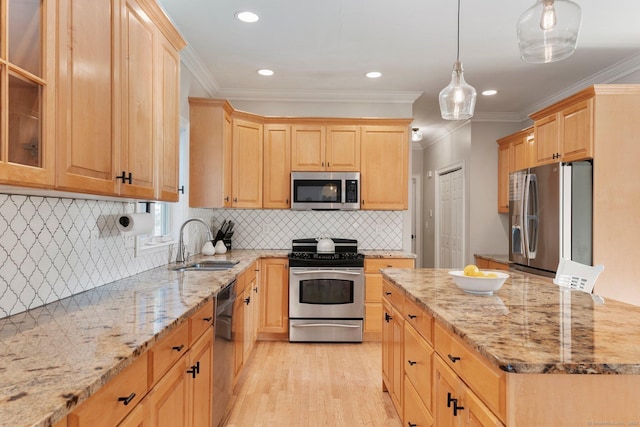 kitchen featuring appliances with stainless steel finishes, a sink, light stone counters, and light brown cabinetry