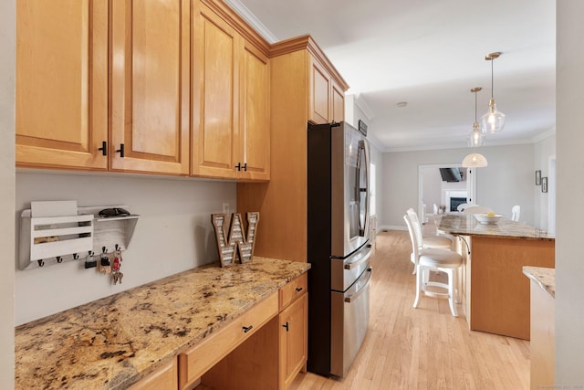 kitchen featuring pendant lighting, stainless steel fridge with ice dispenser, light wood finished floors, crown molding, and light stone countertops