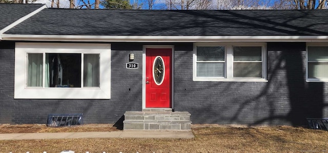 310 Newfield St, Middletown, CT 06457 - doorway to property featuring brick siding and a shingled roof
